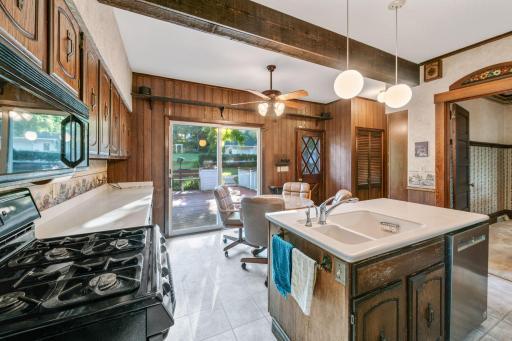 The kitchen is open to the formal dining area to the right, and there is additional pantry-type storage at the back of the kitchen by the closet.