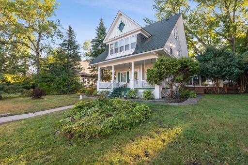 A view of the home that shows the nice covered front porch and the sun room addition on the right side.