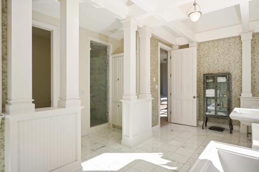 A view of the shower and out to the primary bedroom.