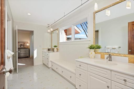 The Jack & Jill bath features double vanities, shower/tub, and ample space for linen storage.