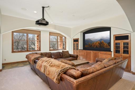 The sizable lower level great room features stylish built-ins for storage.