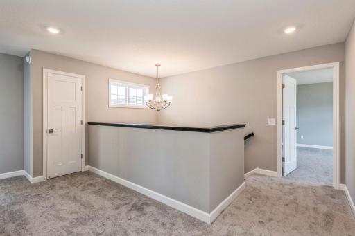Upper level features a spacious hallway with room for a desk or sitting area. Large linen closet, 4 bedrooms, 2 bathrooms and a convenient upstairs laundry room. Actual picture of the home.