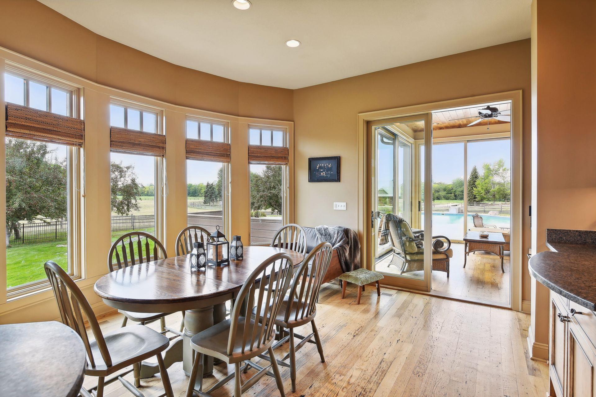 The informal dining area and sunroom provide panoramic views of the expansive acreage