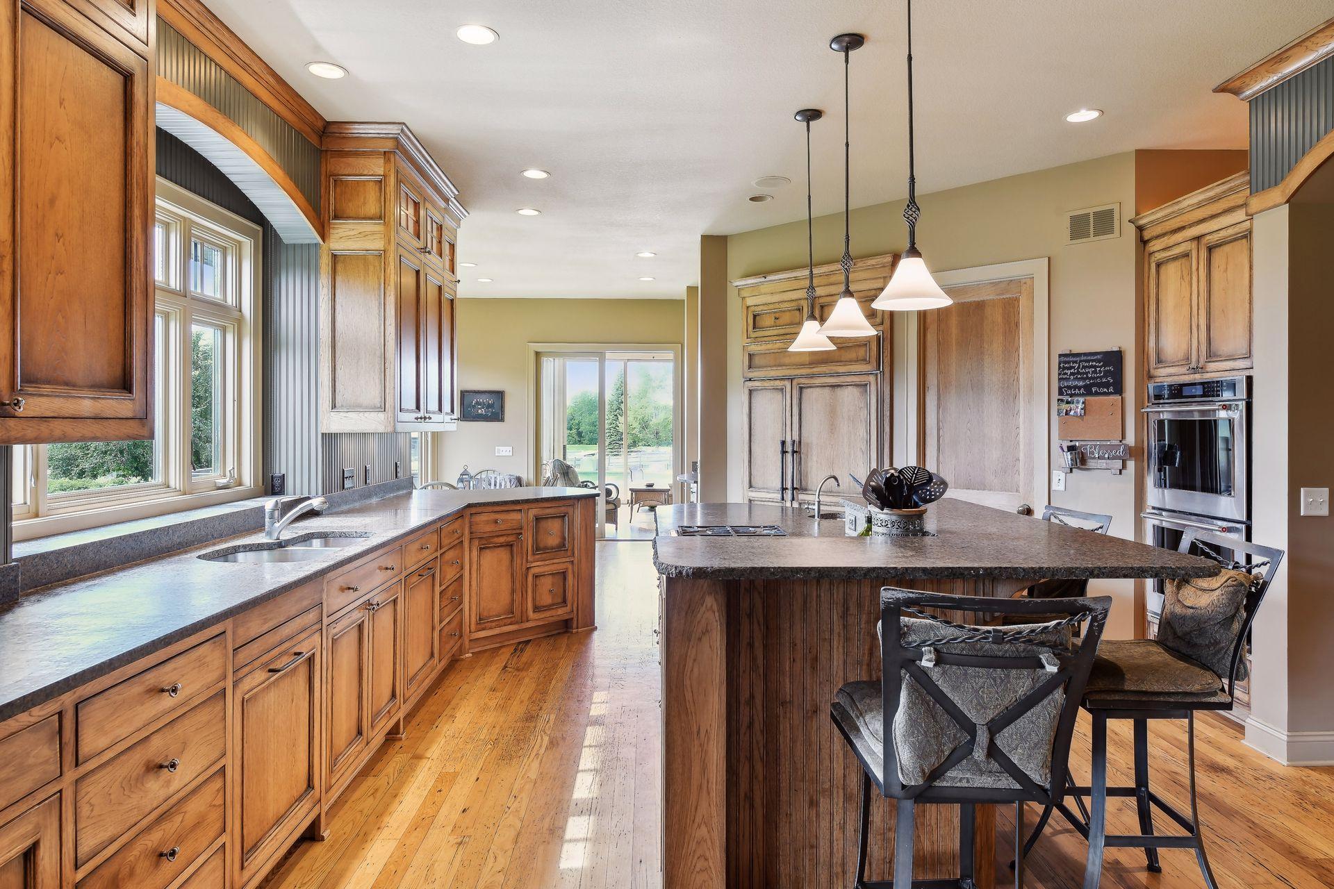 Bright open kitchen with gourmet appliances and walk in pantry.