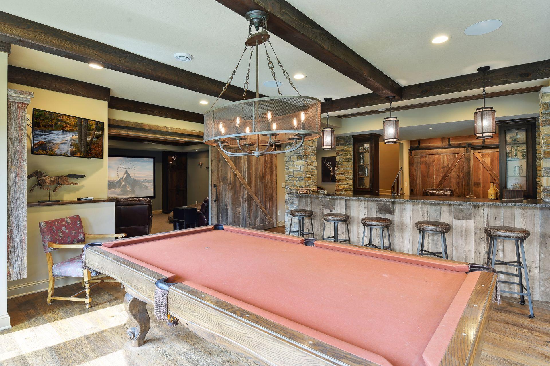 The lower level features an inviting entertaining space that includes a home theater, bar and billiard area
