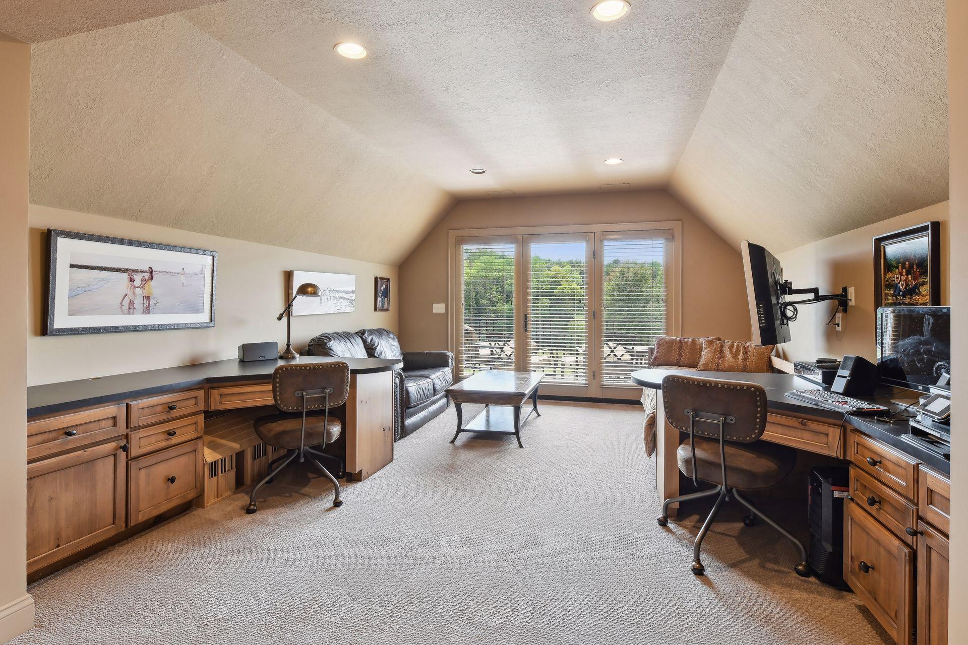 Upper level media room with built in decks, tv viewing area and a 2nd story deck with panoramic views.