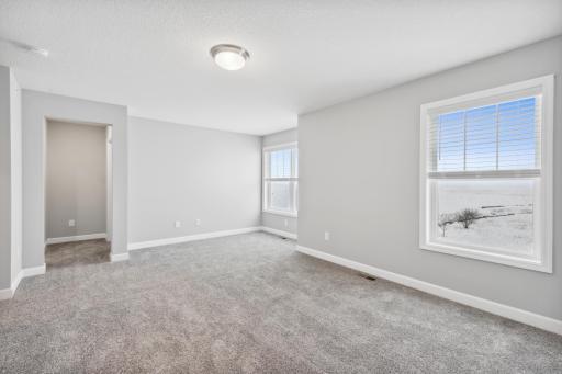 Find your retreat in this stunning owner's suite. Enjoy the exclusivity of a private bath and two huge walk-in closets. (Photo of a completed home, actual home's finishes may vary slightly)