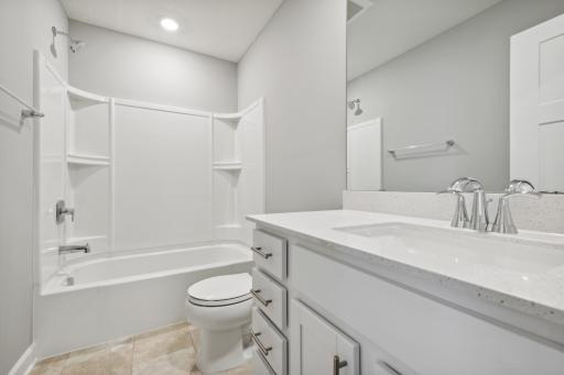 This secondary bath is sure to keep everyone moving during those busy mornings! (Photo of a completed home, actual home's finishes may vary slightly)