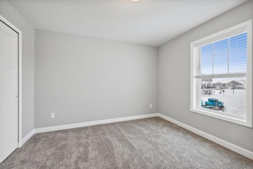 One of two secondary bedrooms upstairs. (Photo of a completed home, actual home's finishes may vary slightly)