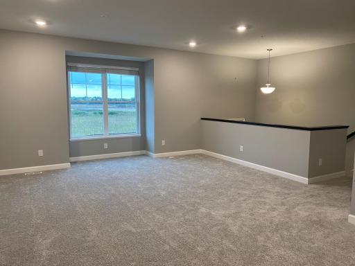 Large great room which opens to the kitchen and dining room. Plus, it features a beautiful wetland view!