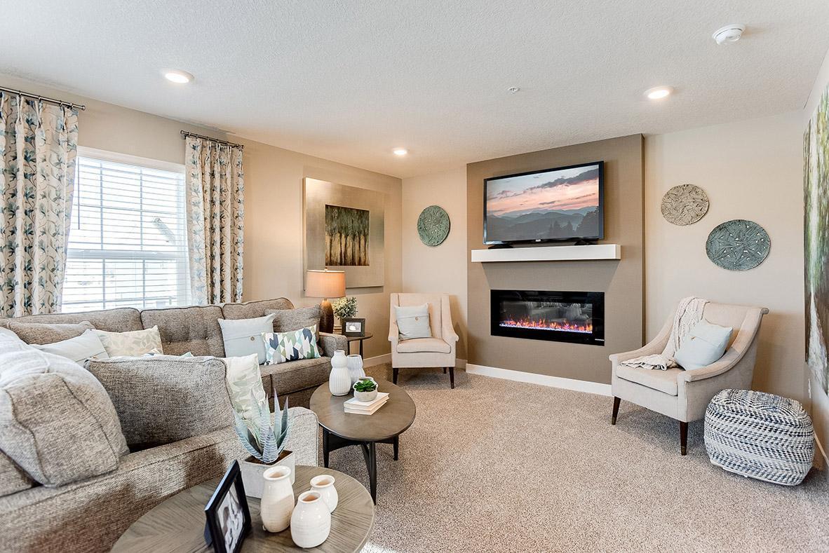 Photo for 12551 Harpers Court NE, D, Blaine, MN 55449 - Listing #6437974 The electric fireplace creates a statement and becomes the focal point in the main floor family room. Model picture shown. Colors and finishes may vary.