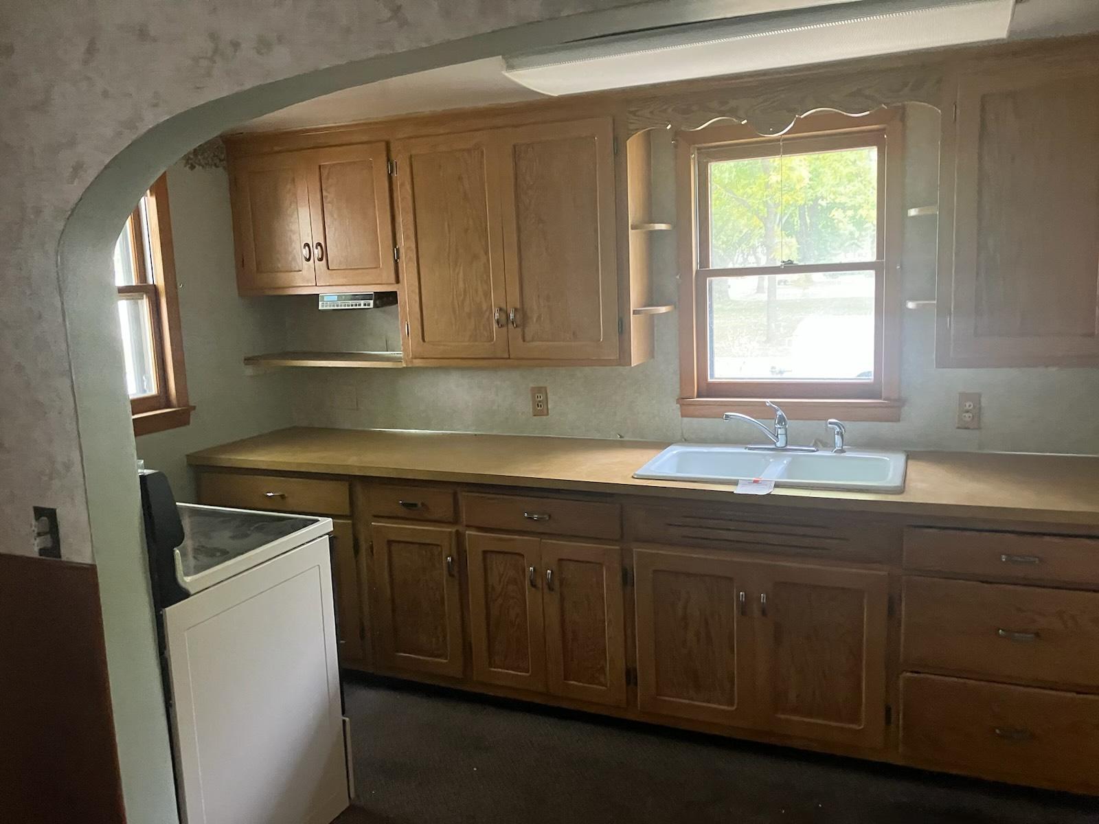 Kitchen with tons of natural lighting and plenty of cabinet storage!