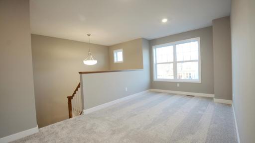 Generously sized upper level loft space, perfect for gathering! (Photo of completed home, actual home finishes may vary slightly)