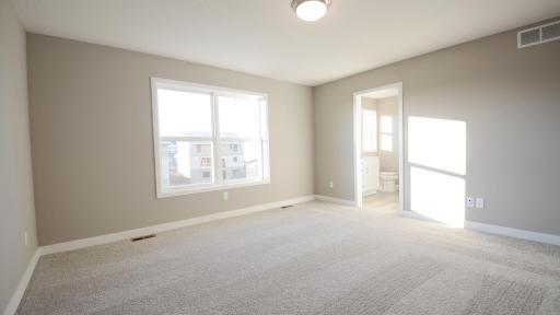 Find your retreat in this stunning owner's suite. Enjoy the exclusivity of a private bath and huge walk-in closet. (Photo of completed home, actual home finishes may vary slightly)