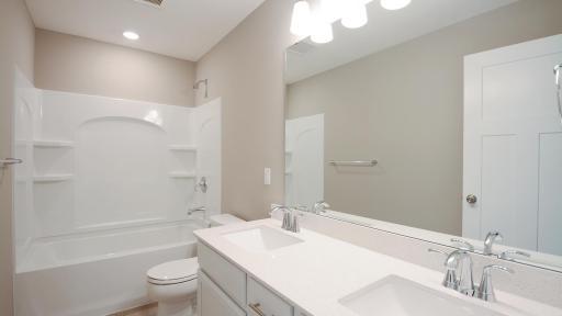 This stunning secondary bath is perfect for those busy morning! (Photo of completed home, actual home finishes may vary slightly)