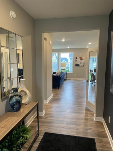 The front foyer is wide and spacious with a lot of natural light coming through.