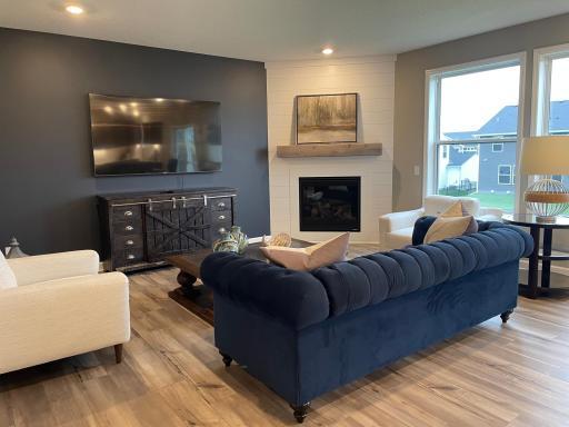 Seamlessly connected, the main family room with the 9' ceiling and large windows enhance the open feel of this space. Enjoy an abundance of natural light and nature views! (Photo of model home, colors and features may vary.)