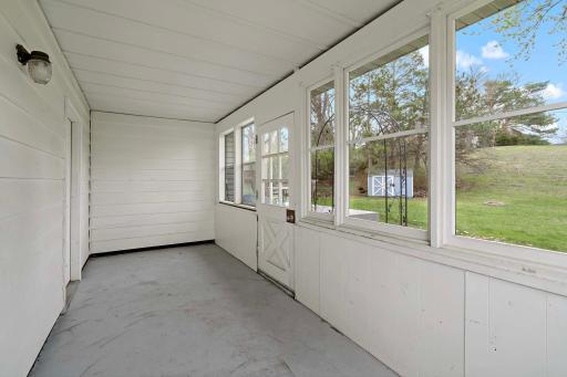 Three season porch off the back of the property is perfect for enjoying bug-less nights!