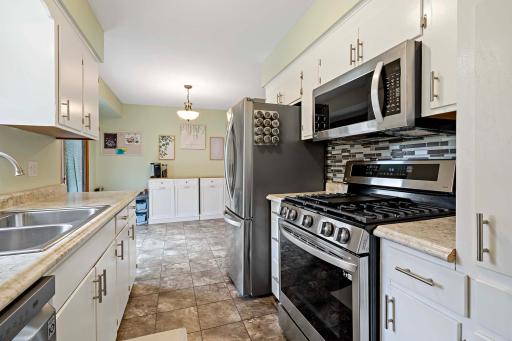 Newer appliances and gas stove in this galley kitchen.