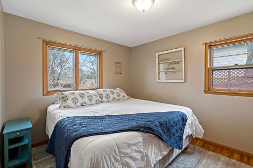 Primary bedroom on the main level features beautiful hardwood floors.