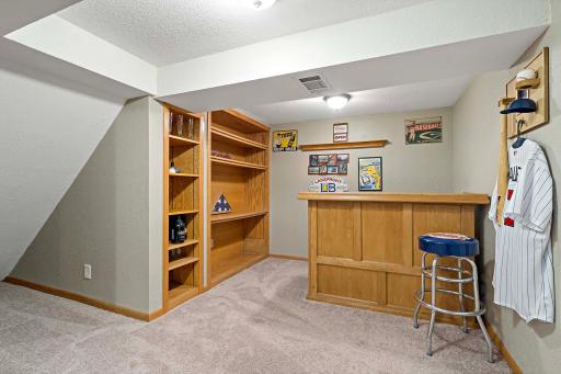 Built ins in the corner of the lower level. Perfect for a bar set up or office space.