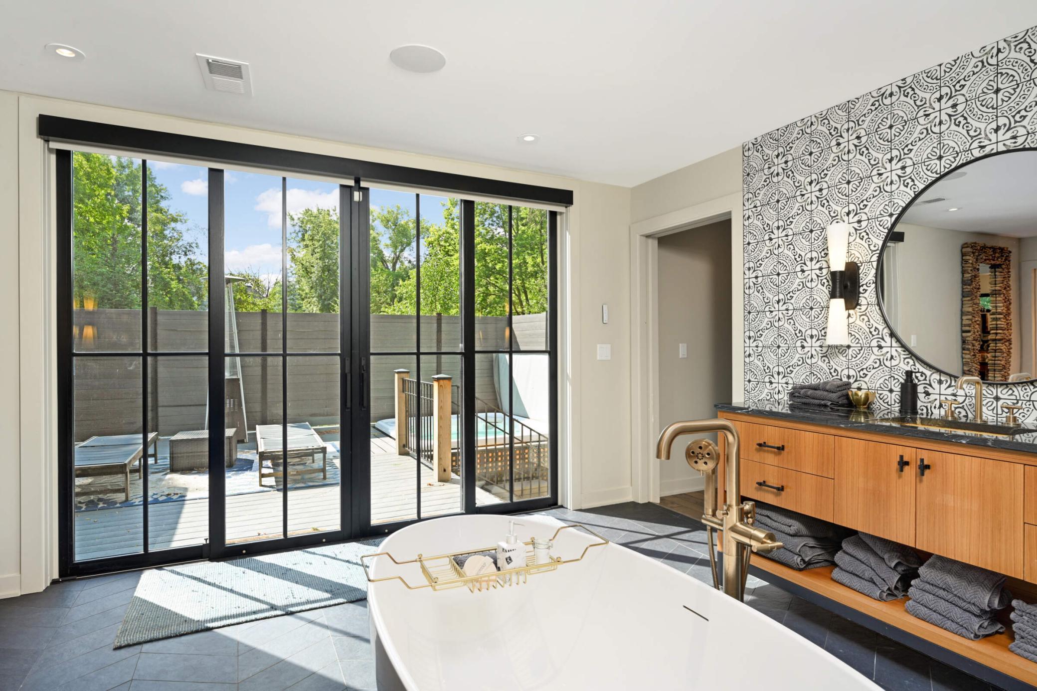 1400sqft Main floor primary ensuite with spa-like bathroom, his and hers vanities, separate Salk-in tub and walk-in shower, and walk out to spa deck