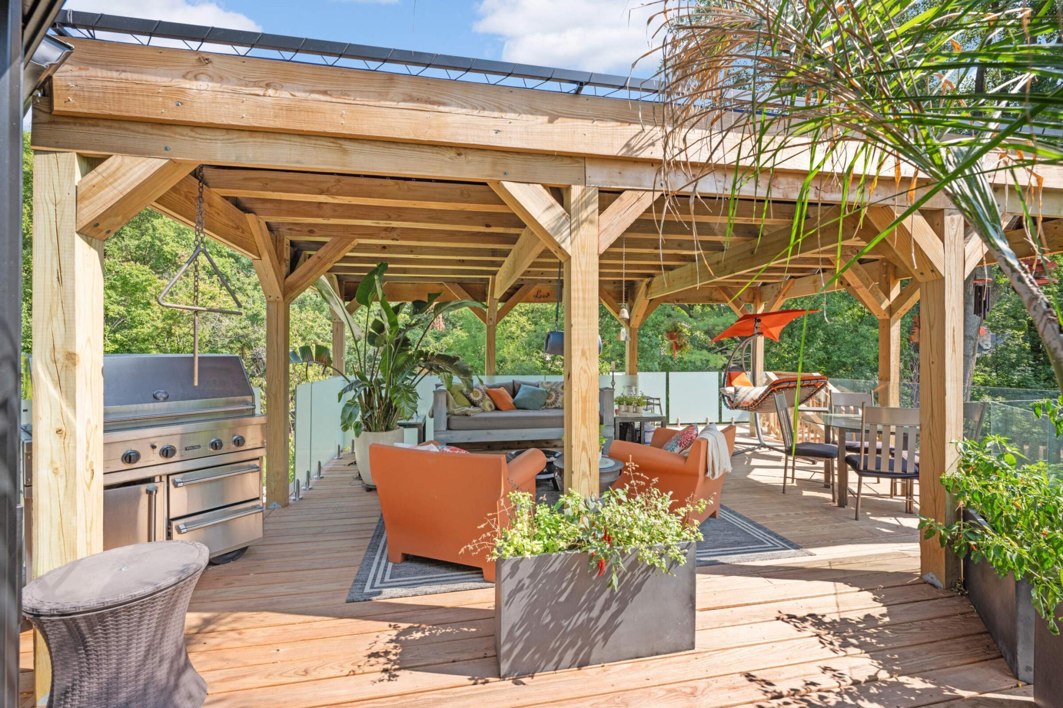 Spectacular covered deck for outdoor main-level entertaining. Built-in gas line for year-round grilling and stairs to the backyard