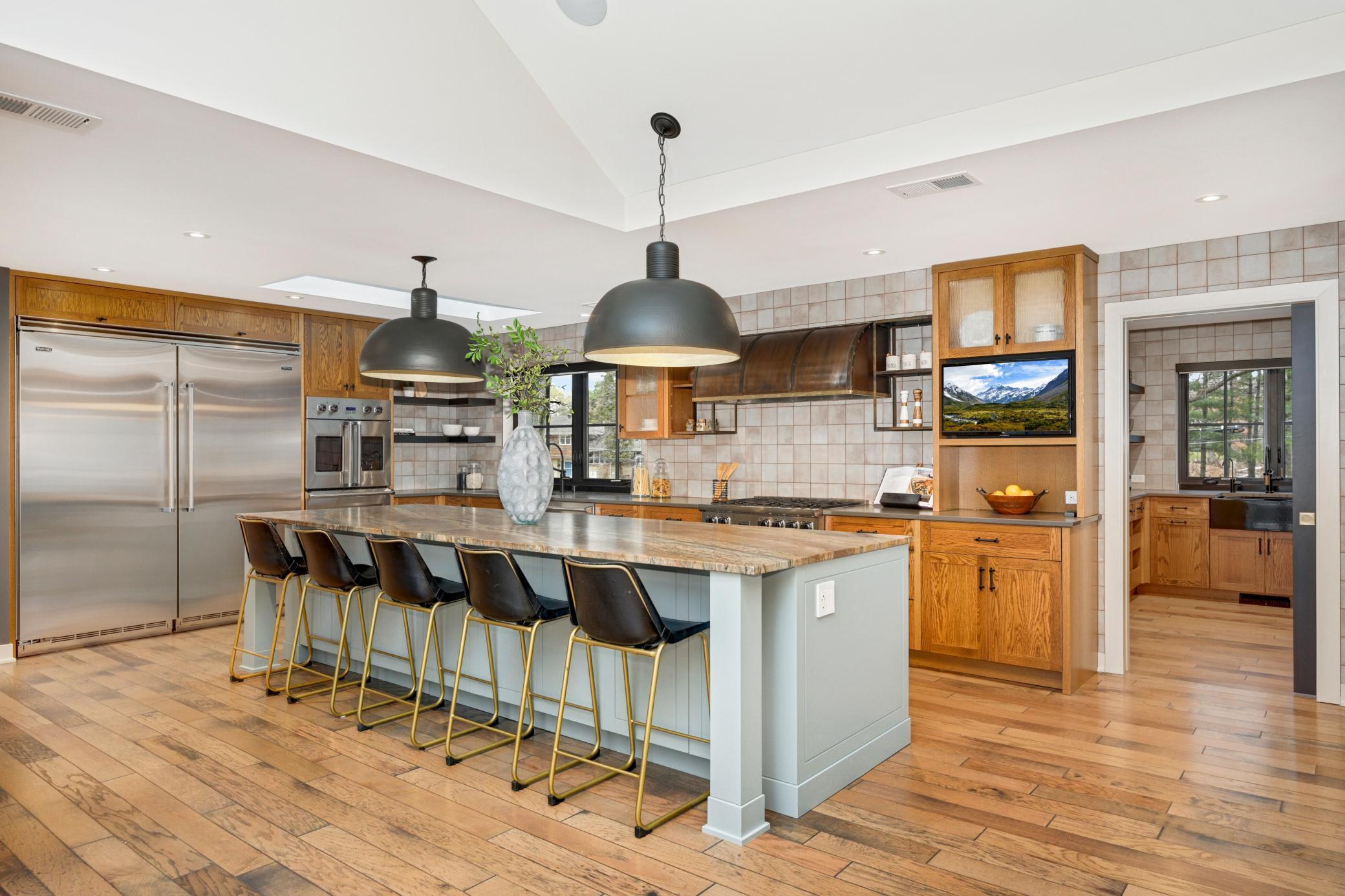 The house with the kitchen in the kitchen! Spectacular gourmet chef setup with Vikings stainless steel appliances, oversized refrigerator, additional warming and cooling drawers, two dishwashers, additional walk-in pantry, etc...