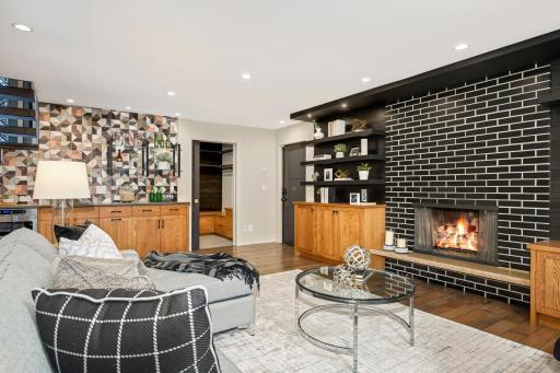 Ground level entertainment room with wet bar, gas fireplace