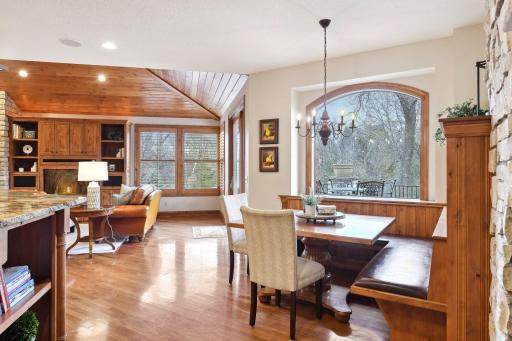 Informal dining area with cozy booth and fireplace.
