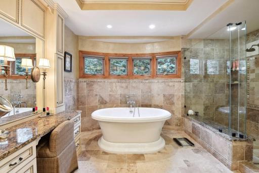 Soaker standing bathtub in primary bathroom.