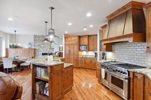 Chef's kitchen with stainless steel appliances and open concept.