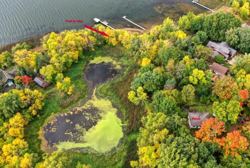 Aerial of pond between the house and the lake