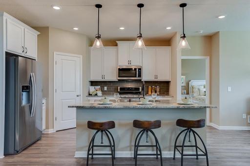 Open and inviting. Spacious corner pantry for all your kitchen appliances with abundant room for cooking and hosting.