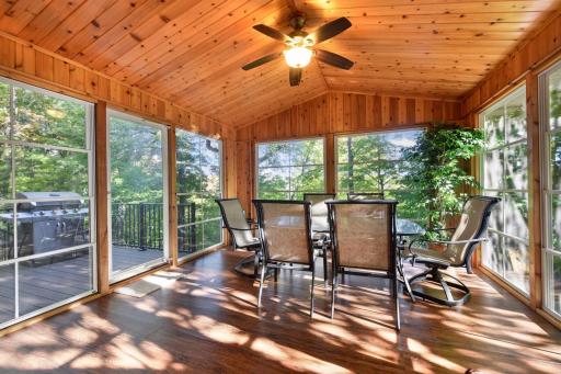 The seasonal screen porch offers a great place to relax and unwind while enjoying the views of the lake