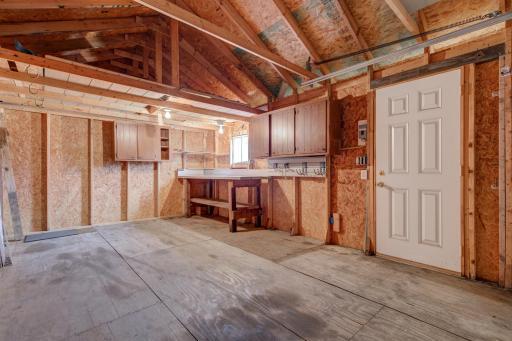 The interior of the detached garage shows it could be used for an outdoor work space as well