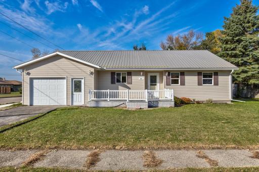 The attached garage adds convenience for parking while the front deck adds character and charm to the exterior
