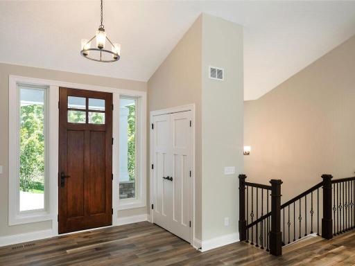 The entryway with custom 8ft entry door flanked with sidelights and coat closet.
