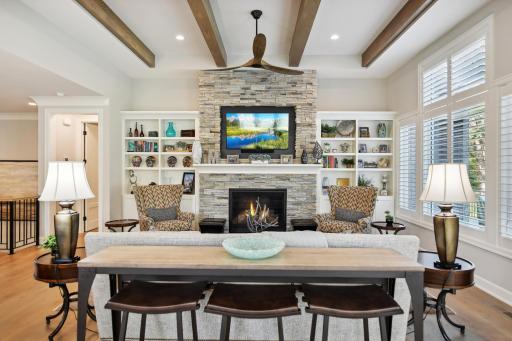 Stack stone surround gas fireplace with gorgeous bookcases. Check out the beams on the ceiling!