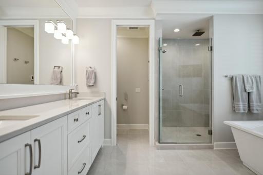 Super primary spa like bath, featuring raised counters, rain shower and ample storage.
