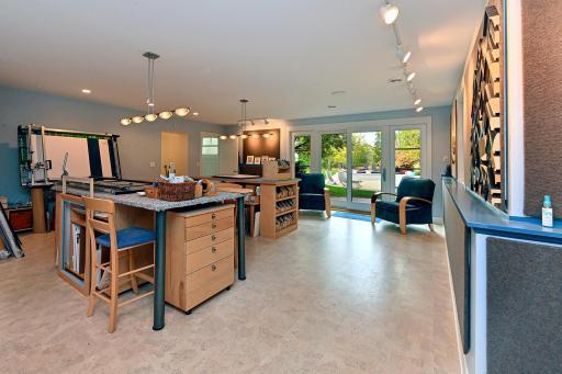 this 22x32 studio room walks out to the pool, this lower level quadrant includes a workshop room and loads of storage space