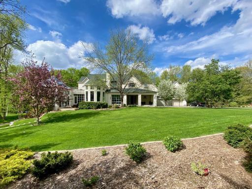 mulched border wraps the lawn with shrubs/perennial varieties