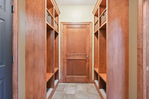 Designed for organization and ease, the Mud Room features four built-in lockers with shoe cubbies and a walk-in coat closet.