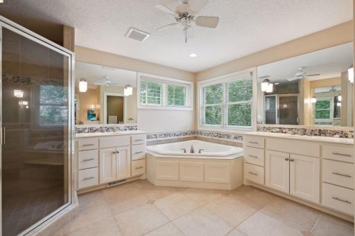 The private Primary Bathroom features separate, comfort height vanities, a jetted bathtub and a spacious tiled shower.