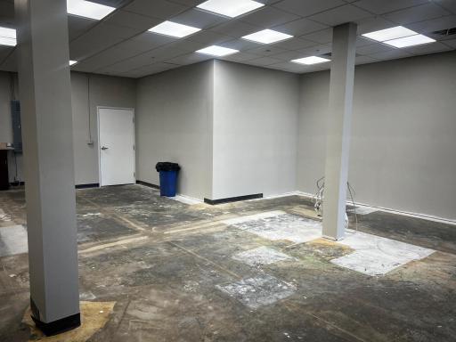 Space prepared with drywall and drop ceiling - ready for flooring installation