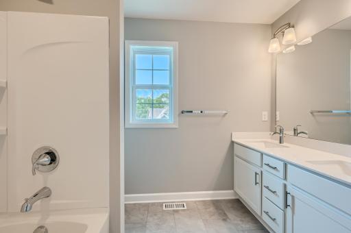 The home's secondary bath features a double-vanity to help keep everyone moving during those busy mornings. Finishes will vary.