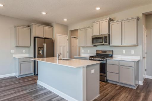 Open and inviting. Spacious pantry for all your kitchen appliances with abundant room for cooking and hosting! Pictures of model home. Selections and colors may vary