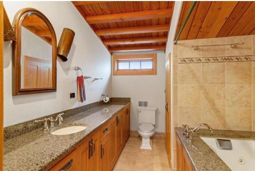 Full private bathroom in loft with tons of counter space and large tub.