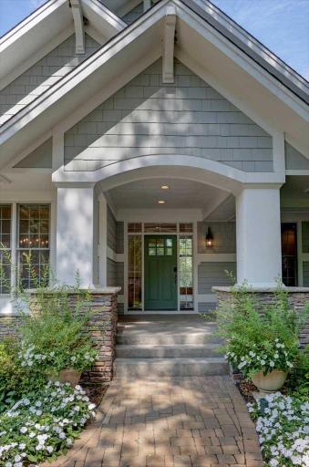Beautiful landscaping greets you at the front porch