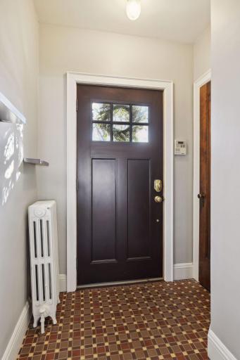Entry with original tilework and coat closet